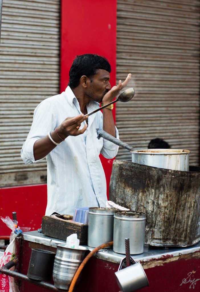 Tea seller tasting tea before serving to customers