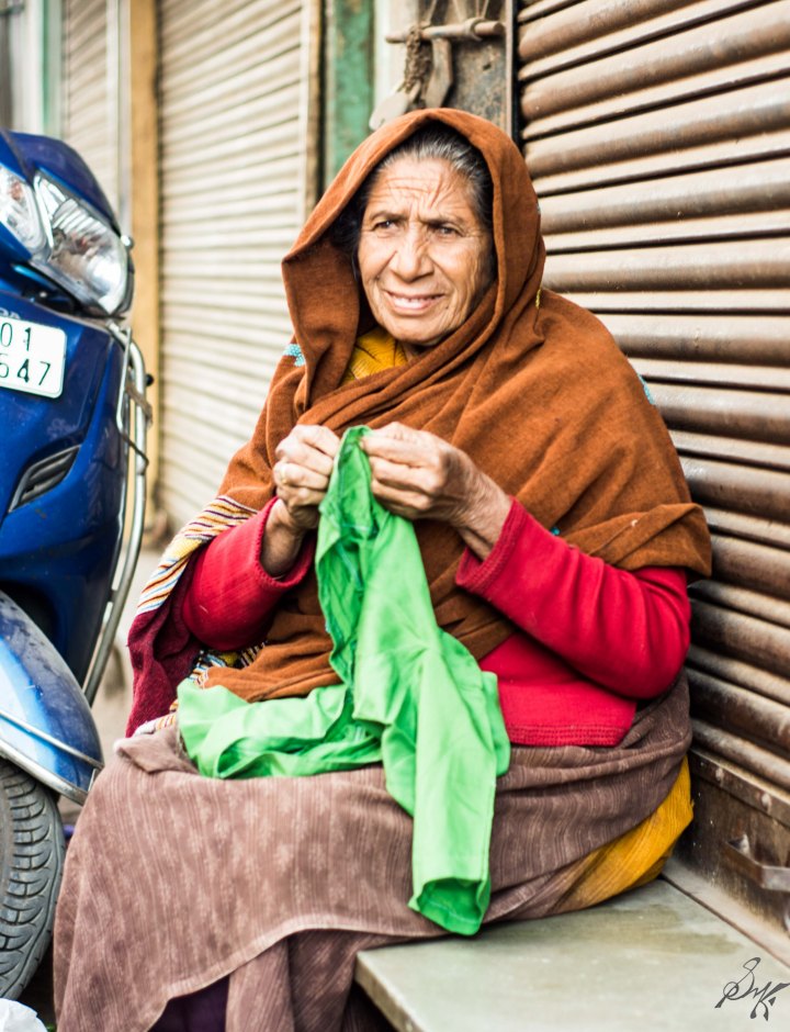 Old lady sewing some cloth in Ahmedabad, Gujarat