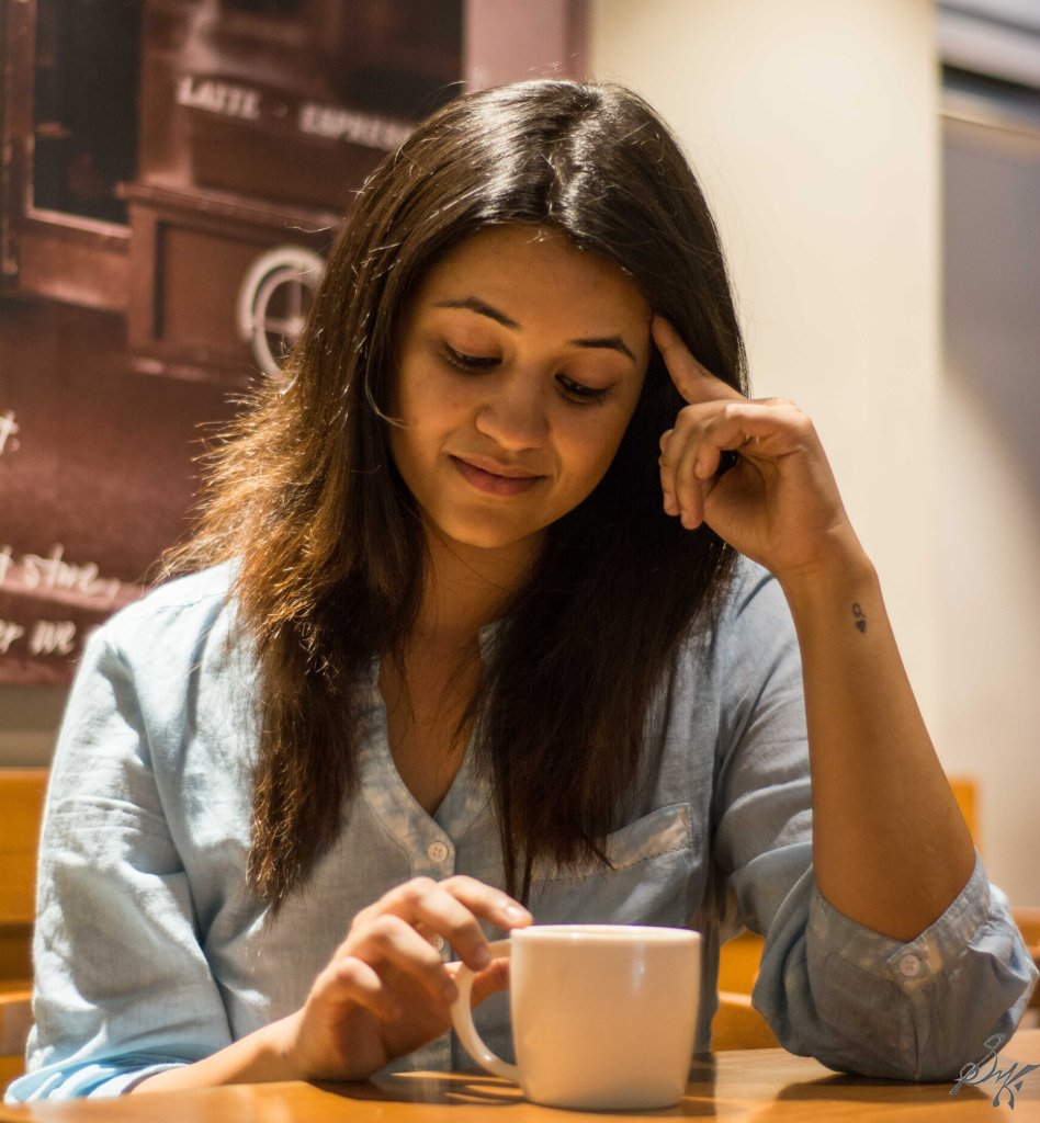 Girl sitting in a coffee shop thinking of past