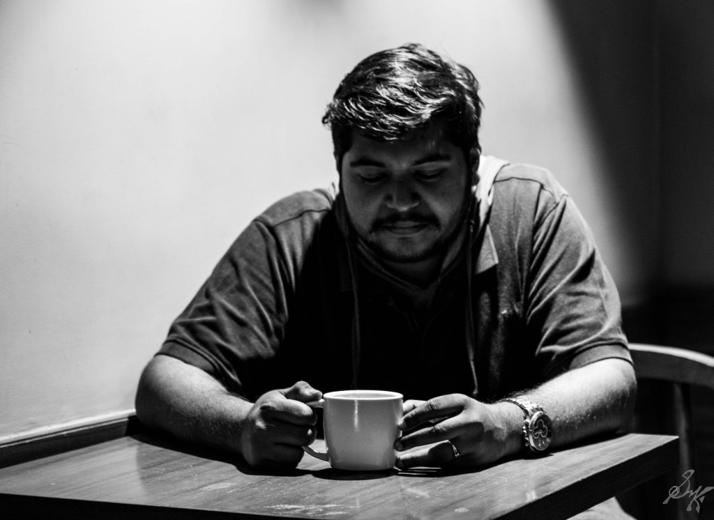 Man thinking with a cup of coffee