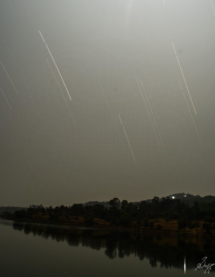 Star trail photo over landscape. Multiple long exposure photos combined in one. Star trail photo over landscape. Multiple long exposure photos combined in one.