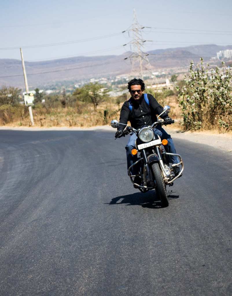Man on Royal Enfield Bullet taking a turn