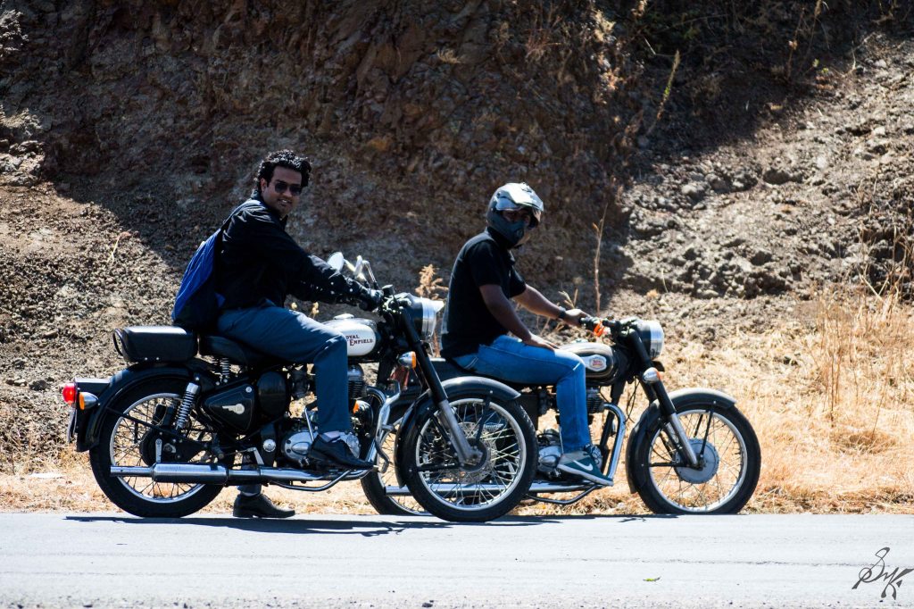 Two men posing with Royal Enfield Bullet
