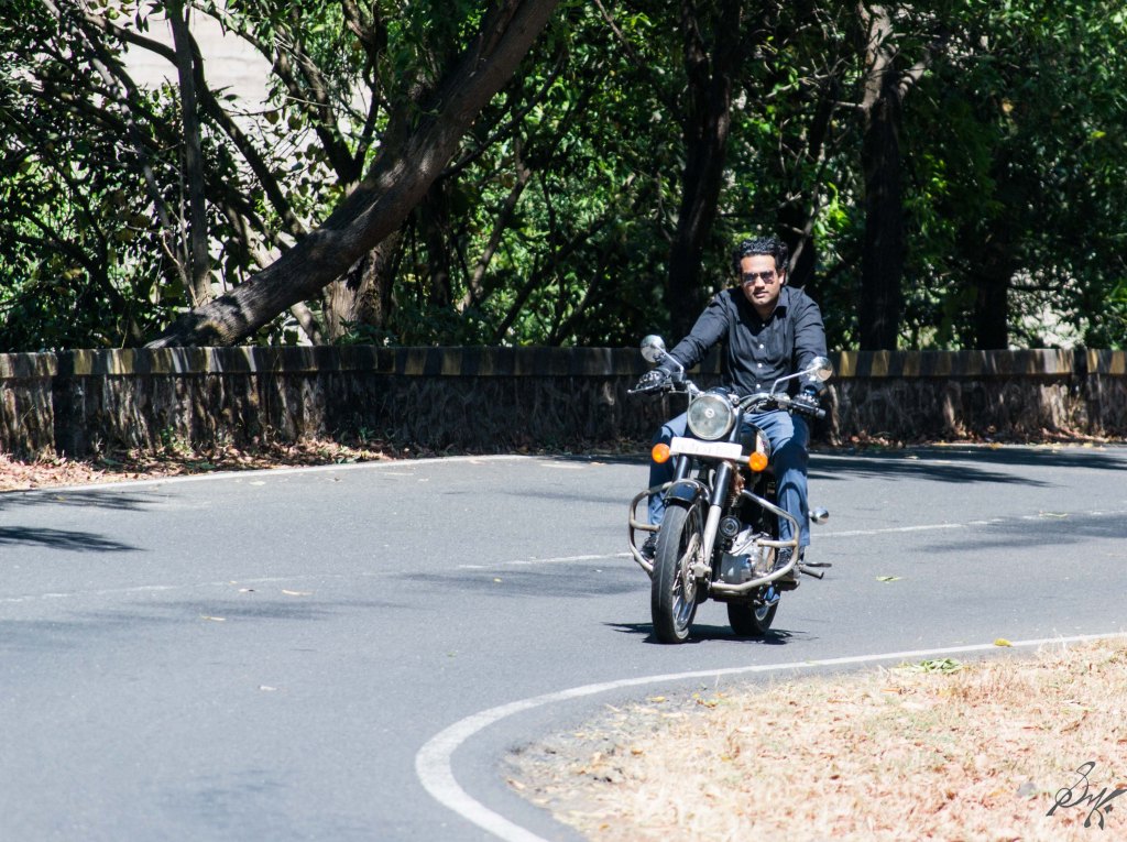 Man on Royal Enfield Bullet taking a turn