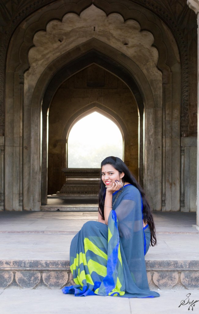 Girl sitting on the steps of the mausoleum, Delhi, India