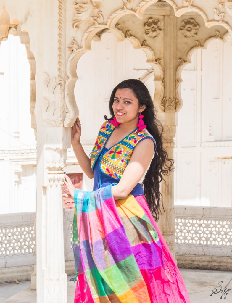 Girl posing with a column at City Palace, Alwar, Rajasthan