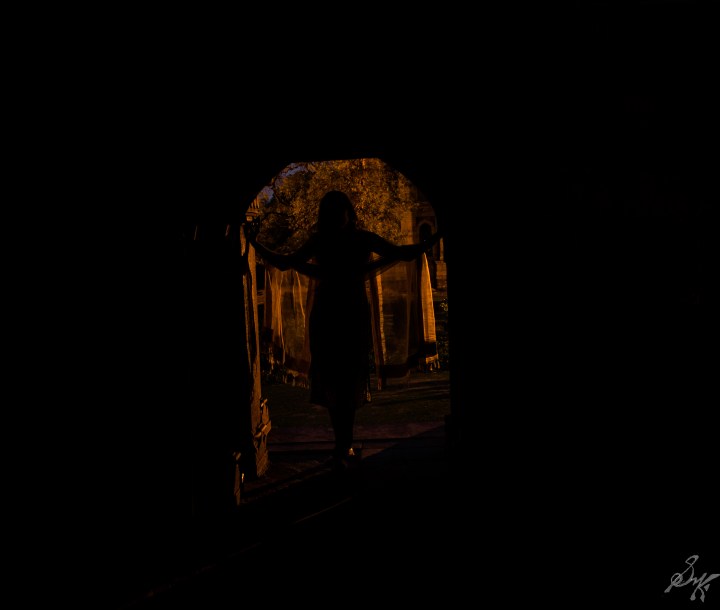 Girl standing at the doorway of Lodi Gardens, New Delhi, India