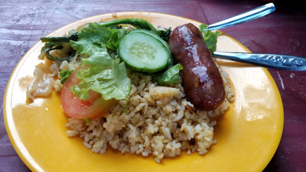 Sticky rice, vegetables and a pork sausage